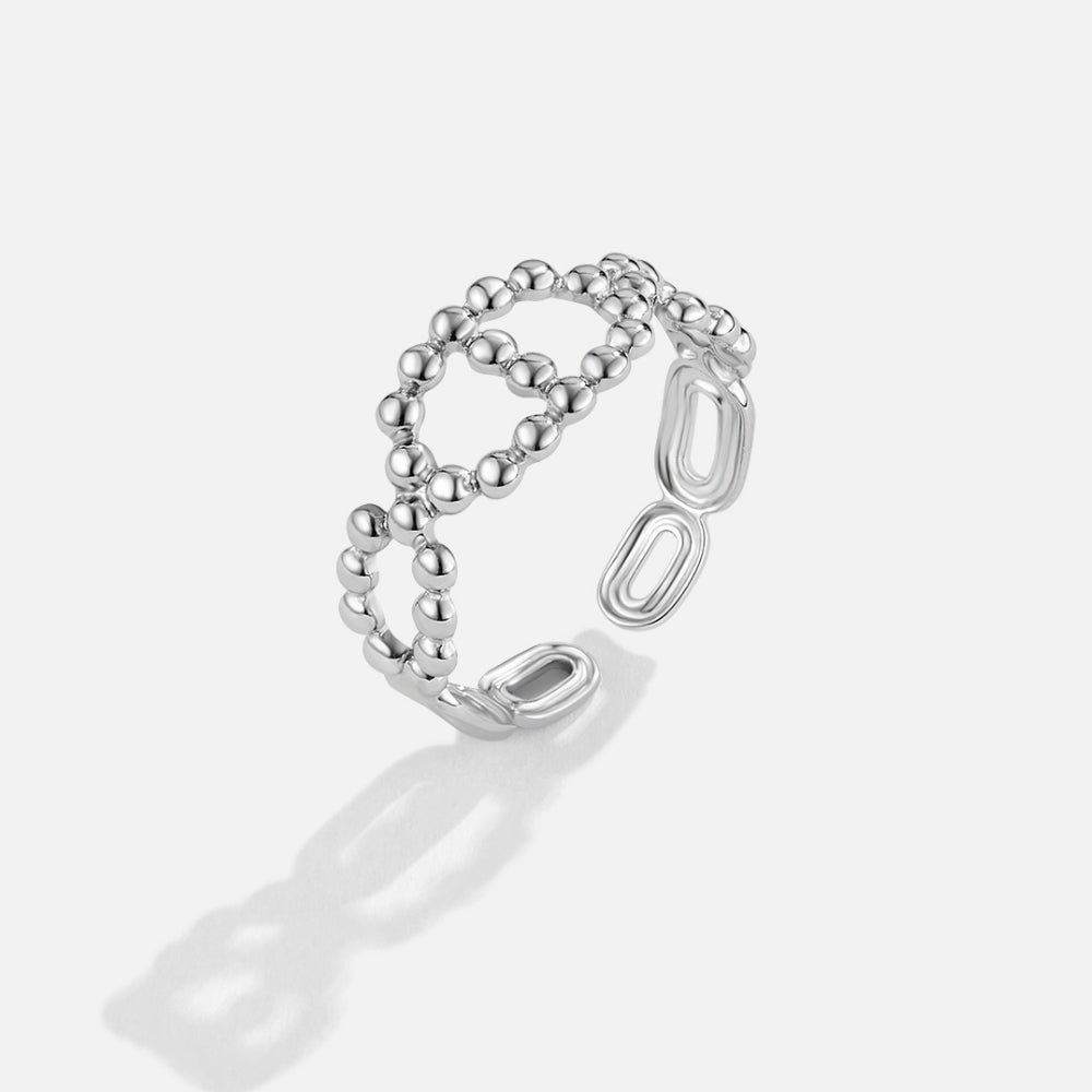 Silver Yulah Chain Ring, open silver ring on plain light background, beaded and oval link design