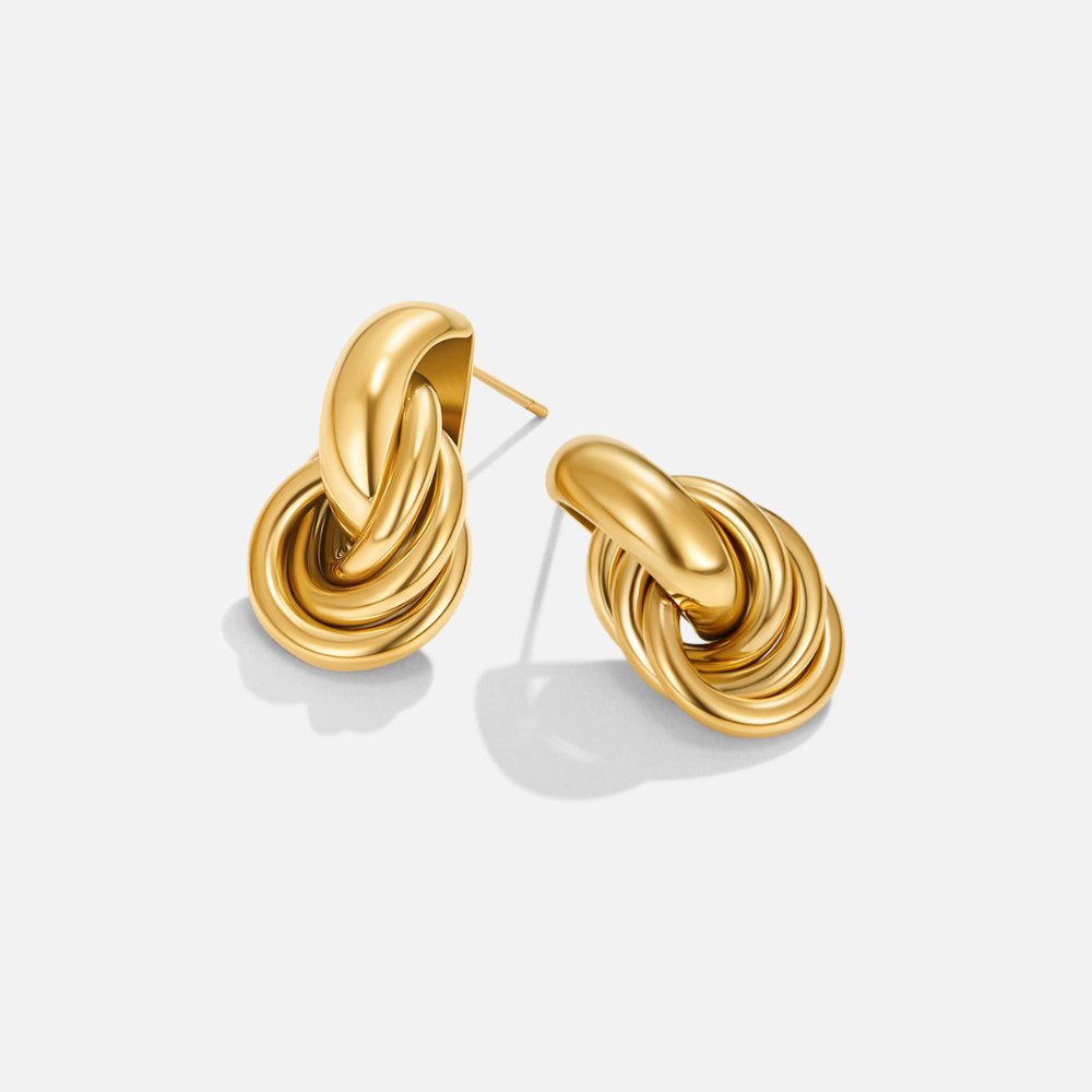 Sofia Twisted Gold Hoop Earrings, pair of gold knot earrings on a plain white background