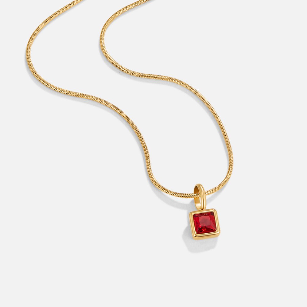 Square Pendant Birthstone Necklace, laid flat on white, gold chain with red square pendant
