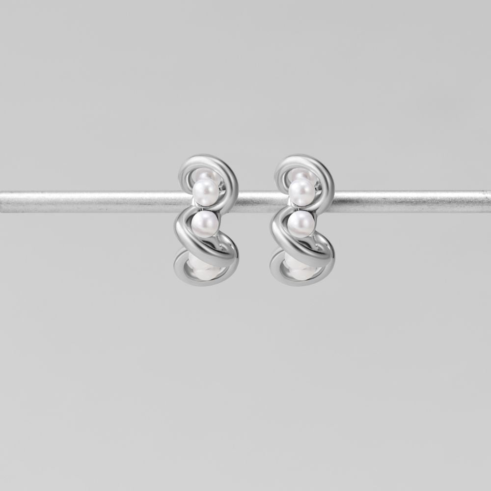 Tara Silver Entwined Pearl Earrings, a pair of silver earrings hanging on a silver rod, two