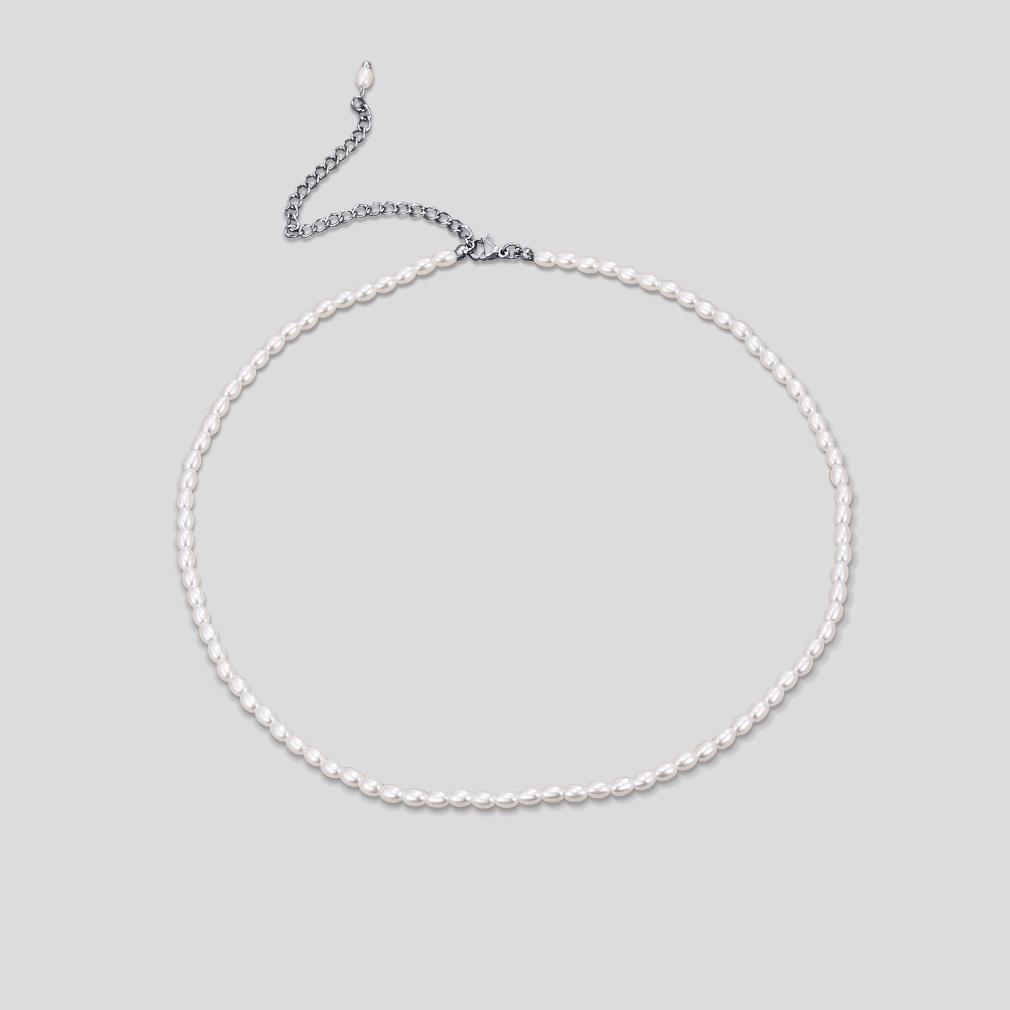 Temi Pearl Silver Necklace, flat lay of a necklace of small oval white pearls with silver