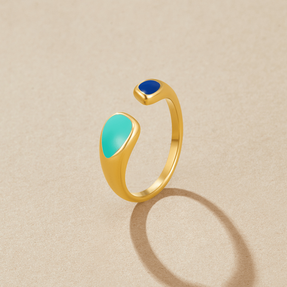 Turquoise Sahara Wrap Ring, open gold ring with turquoise and royal blue enamel ends on beige