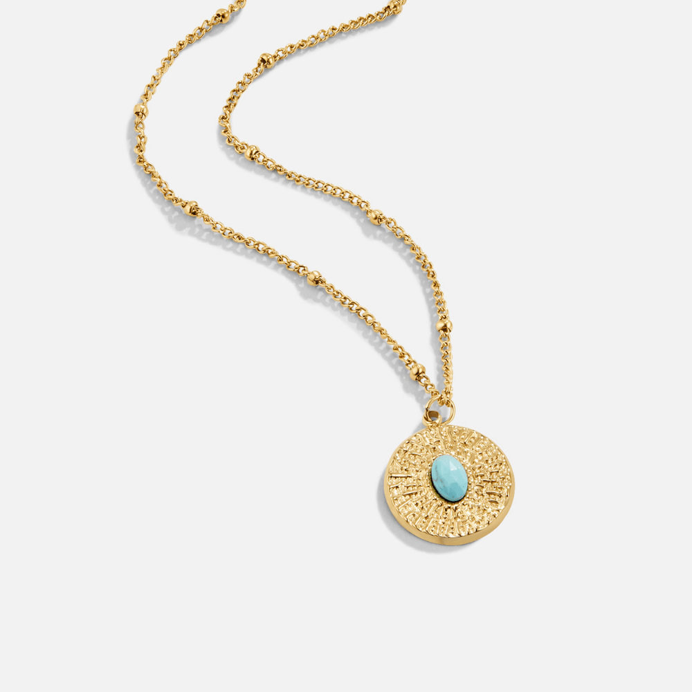 Turquoise Stone Coin Necklace, laid flat on white, round coin pendant with turquoise stone