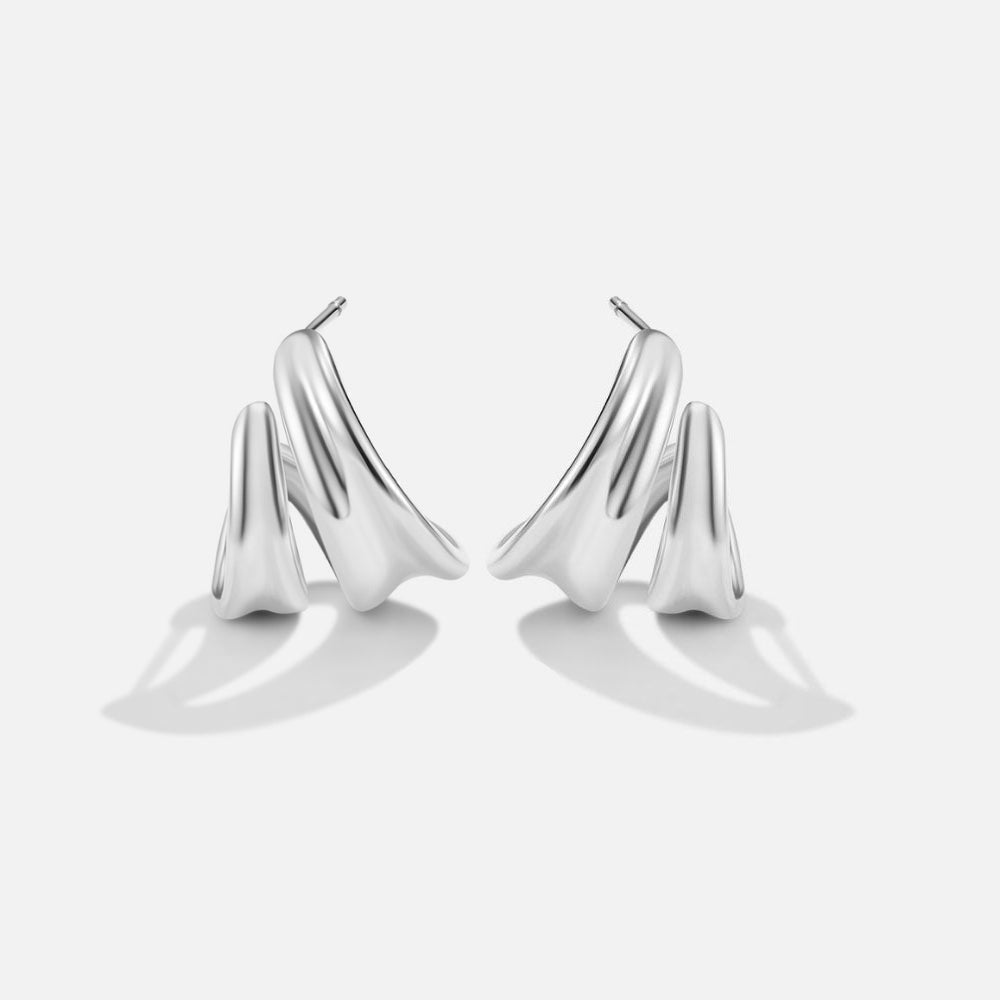 Twisted Ivana Silver Hoop Earrings, pair of sculpted silver earrings on a plain white background