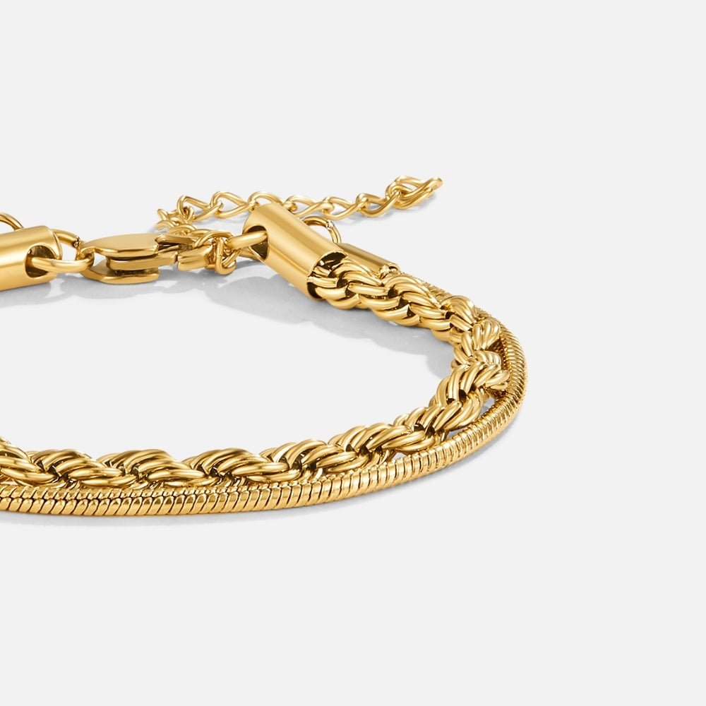Twisted Leila Layered Bracelet, close-up of two gold chains layered on a plain background