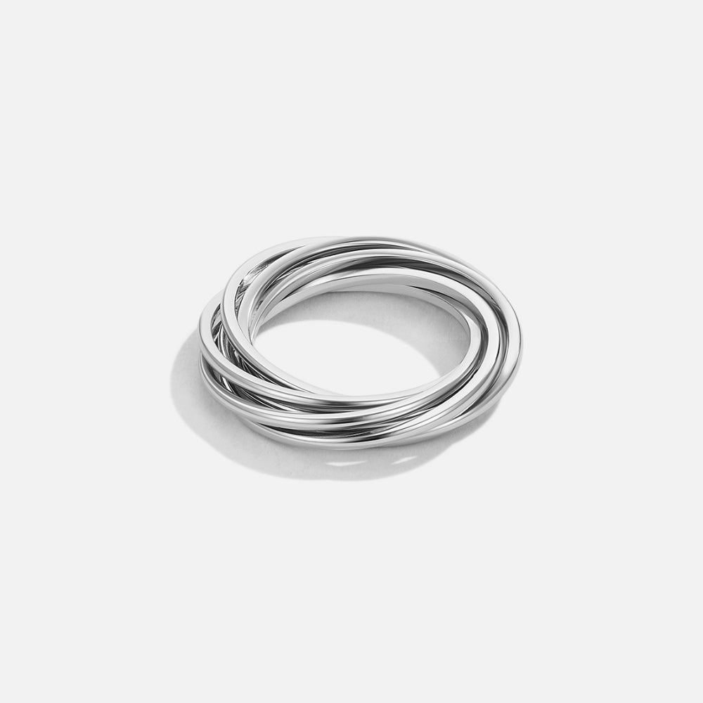 Twisted Mia Silver Ring, several polished silver bands interlinked on a plain light background