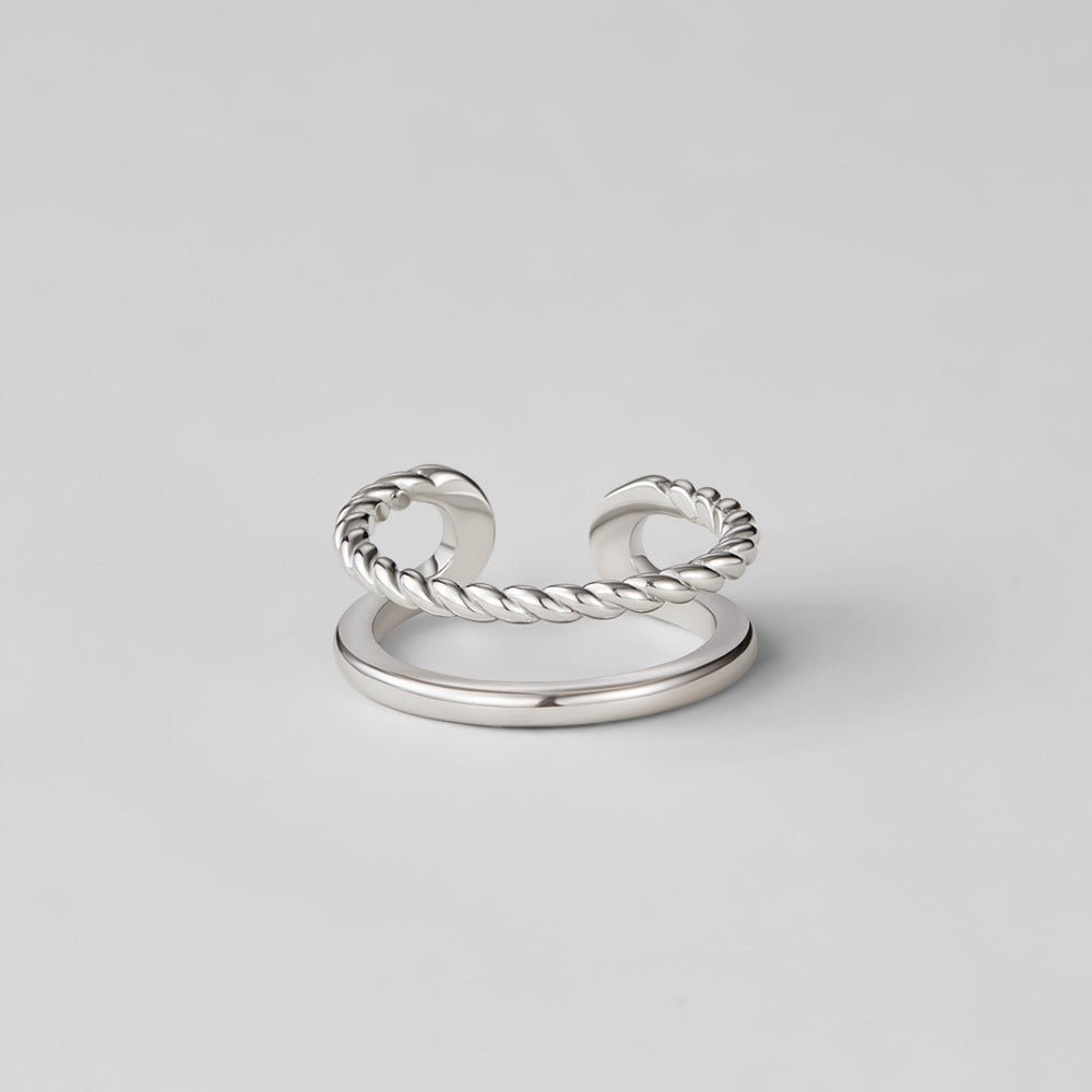 Twisted Tyra Silver Ring, silver ring on plain grey background, twisted rope band above smooth band