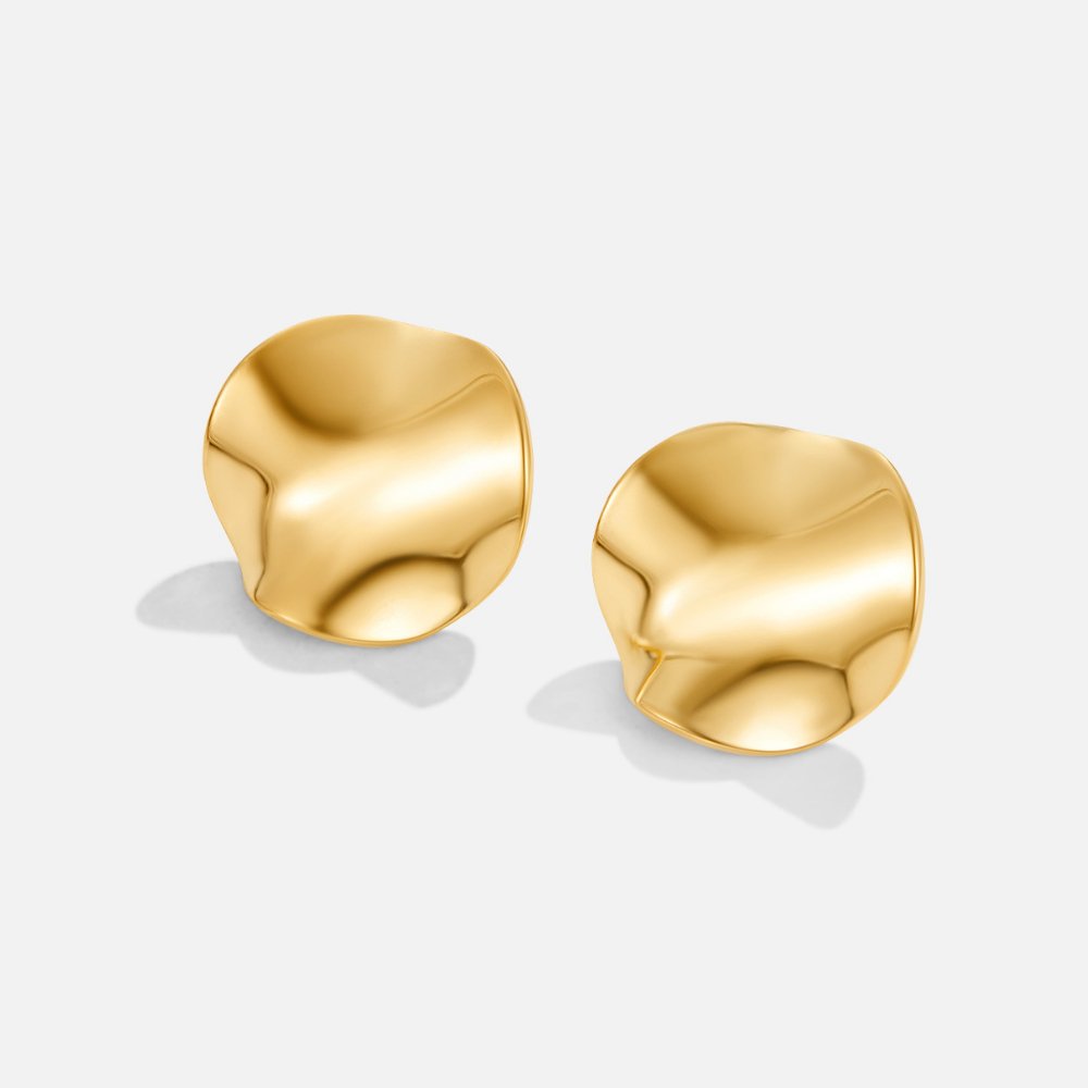 Tyra Gold Earrings, pair of gold earrings with dented, wavy round discs on white