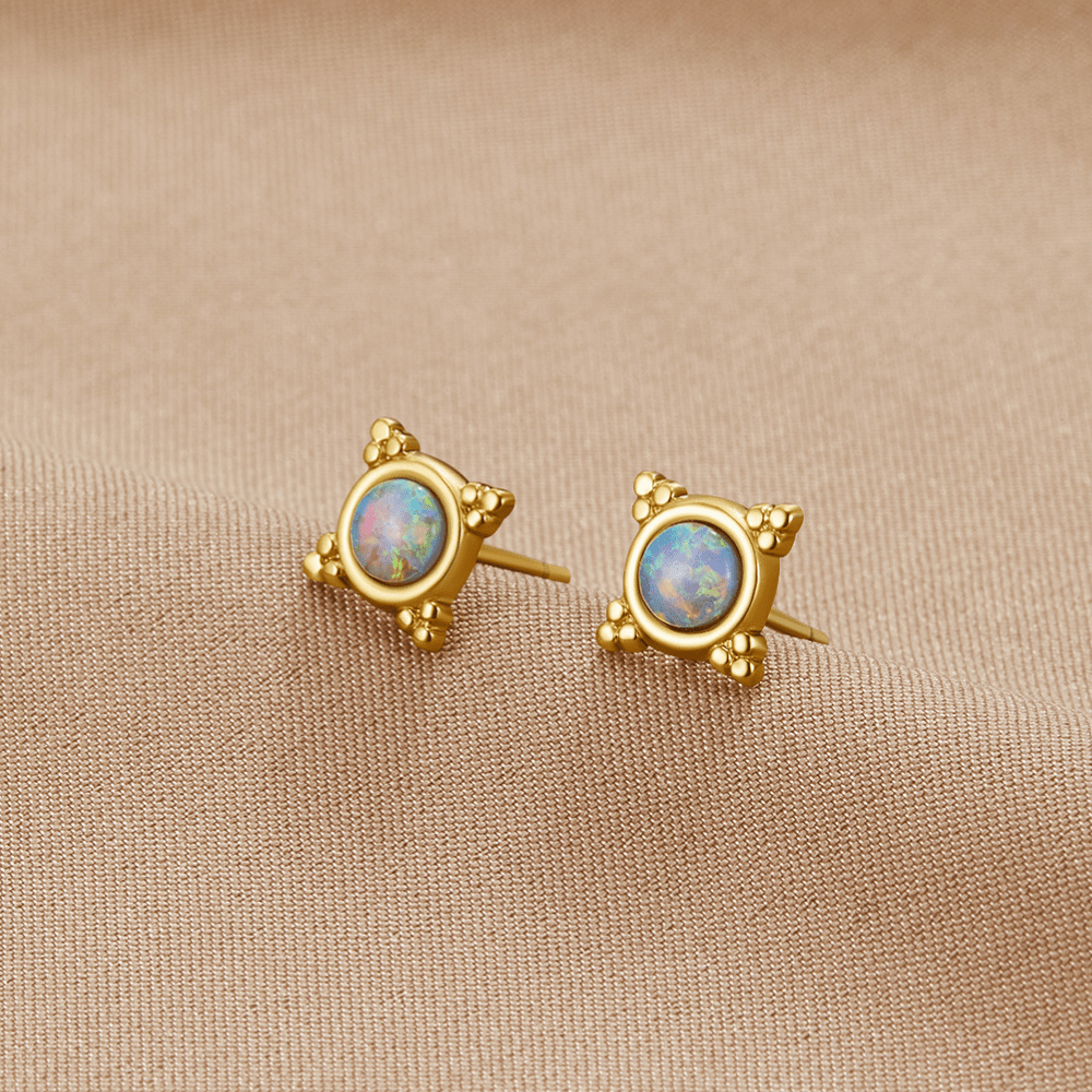 Vintage Blue Opal Stud Earrings, a pair of studs on beige fabric, gold with opal centres