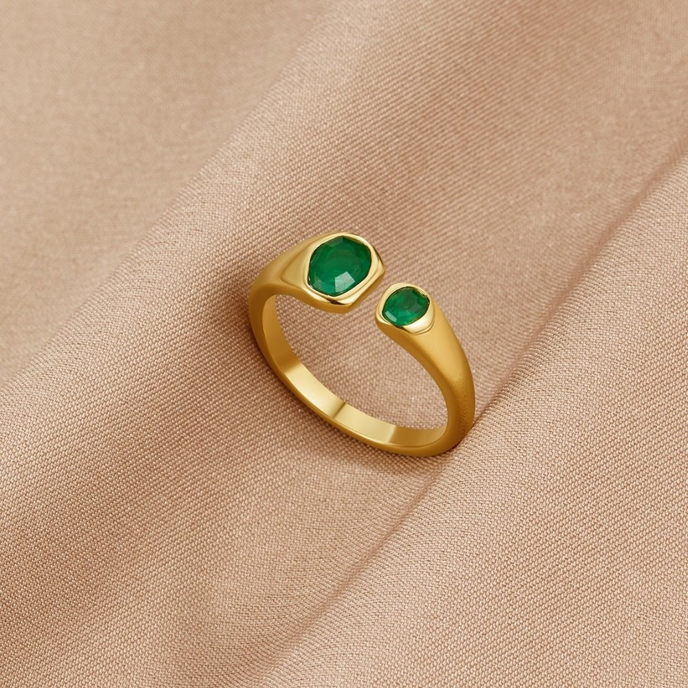 Vintage Green Emerald Wrap Ring, open gold ring with two green stones on beige fabric