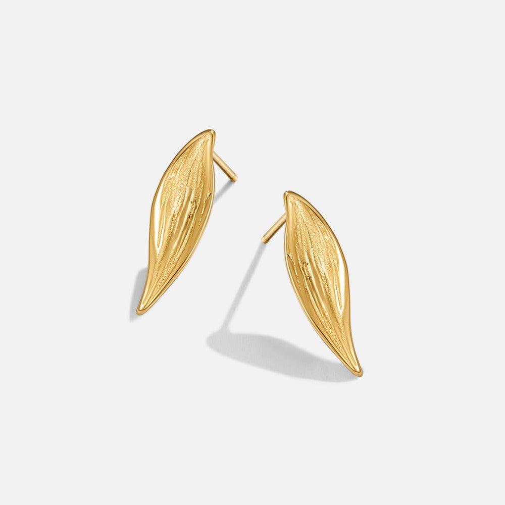 Vintage Monet Gold Leaf Earrings, pair of gold leaf-shaped stud earrings on a plain white background