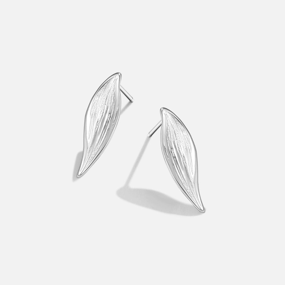 Vintage Monet Silver Leaf Earrings, pair of silver leaf studs on a plain white background