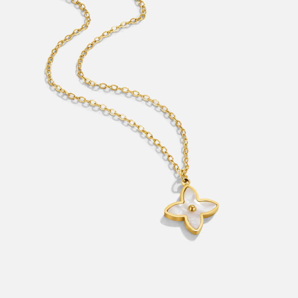 White Blossom Petal Necklace, gold chain laid diagonally with a four-petal white pendant