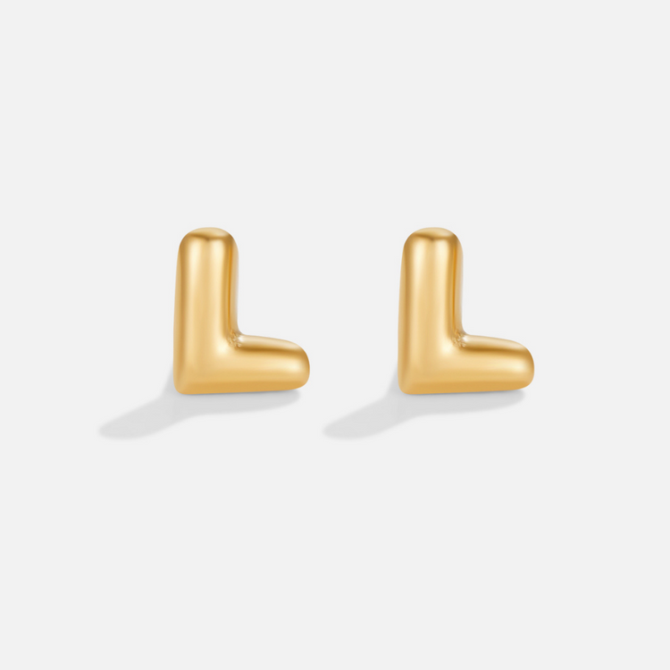 Gold Bubble Letter Earrings, two glossy gold letter L stud earrings on a plain light background