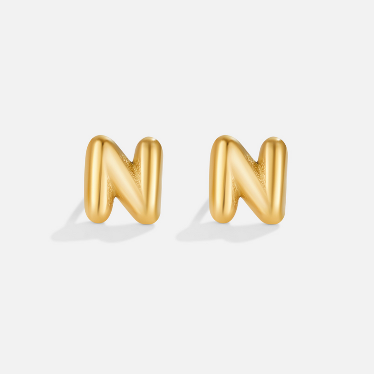 Gold Bubble Letter Earrings, a pair of puffy gold letter N studs on a plain light background