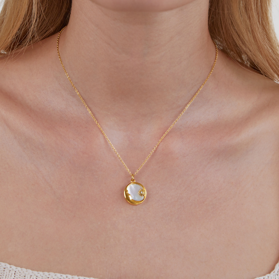 'Dreaming in the Clouds' Moon & Star Necklace, worn on a neck with a fine gold chain, pearly pendant