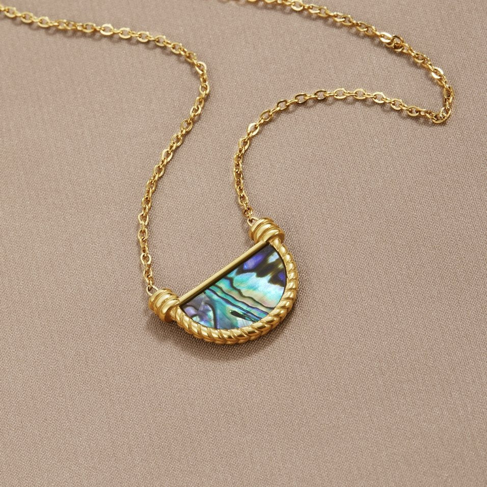 Amalfi Turquoise Jewelry Set, laid flat on beige fabric, gold chain with half-moon abalone
