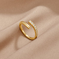 Arya Gold & Crystal Wrap Ring, lying on beige satin, open wrap band with crystal row