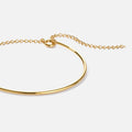 Aspen Gold Bracelet, close-up of a polished gold bangle with chain extender on white