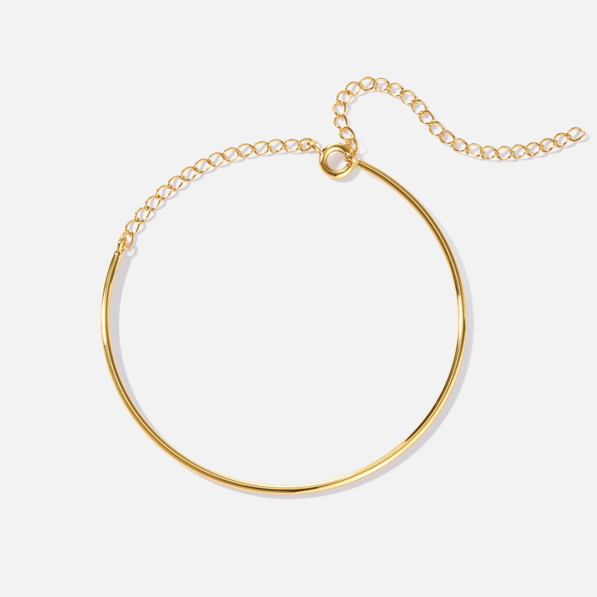 Aspen Gold Bracelet, flat-lay of a thin gold bangle with a chain extender on white
