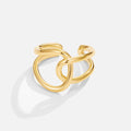 Astrid Gold Ring, polished gold ring of interlocking loops on a white background, open band