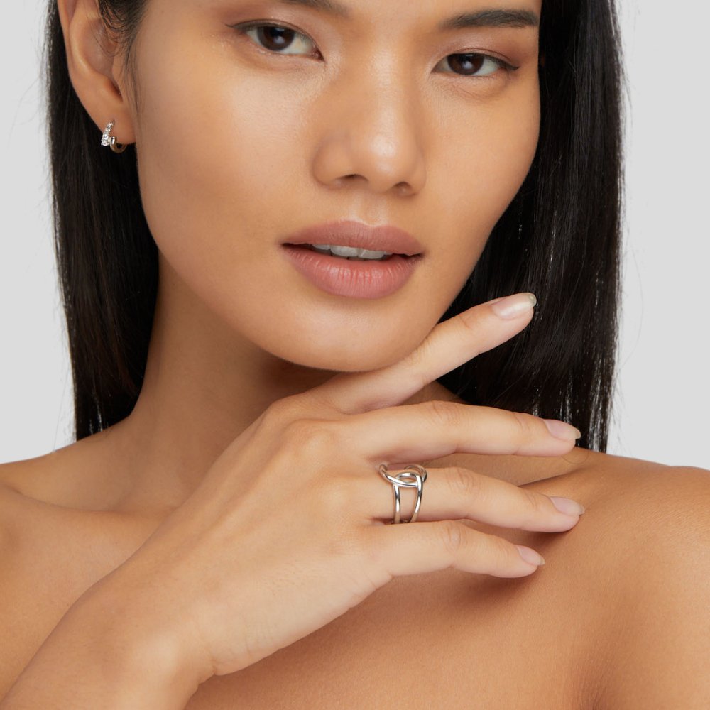 Astrid Silver Ring, worn on a hand touching a model's chin, silver ring visible
