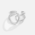 Astrid Silver Ring, polished silver ring of interlinked open loops on a pale background