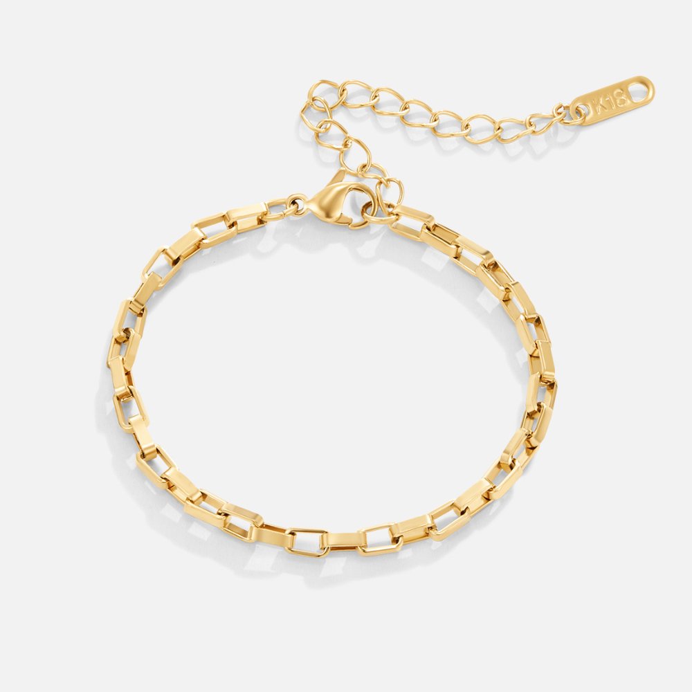 Aura Chain Gold Bracelet, flat lay of a gold chain bracelet with clasp and extender tag