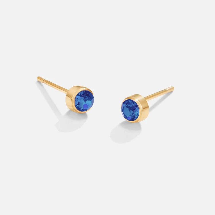 Birthstone Stud Earrings, pair of gold studs with round blue stones, on a plain background