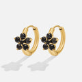 Black Crystal Flower Hoop Earrings, a pair of gold hoops with black flower-shaped stones on white