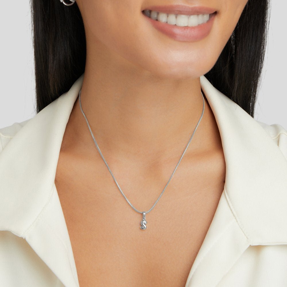 Bubble Letter Necklace, worn on a smiling model in a cream collared top