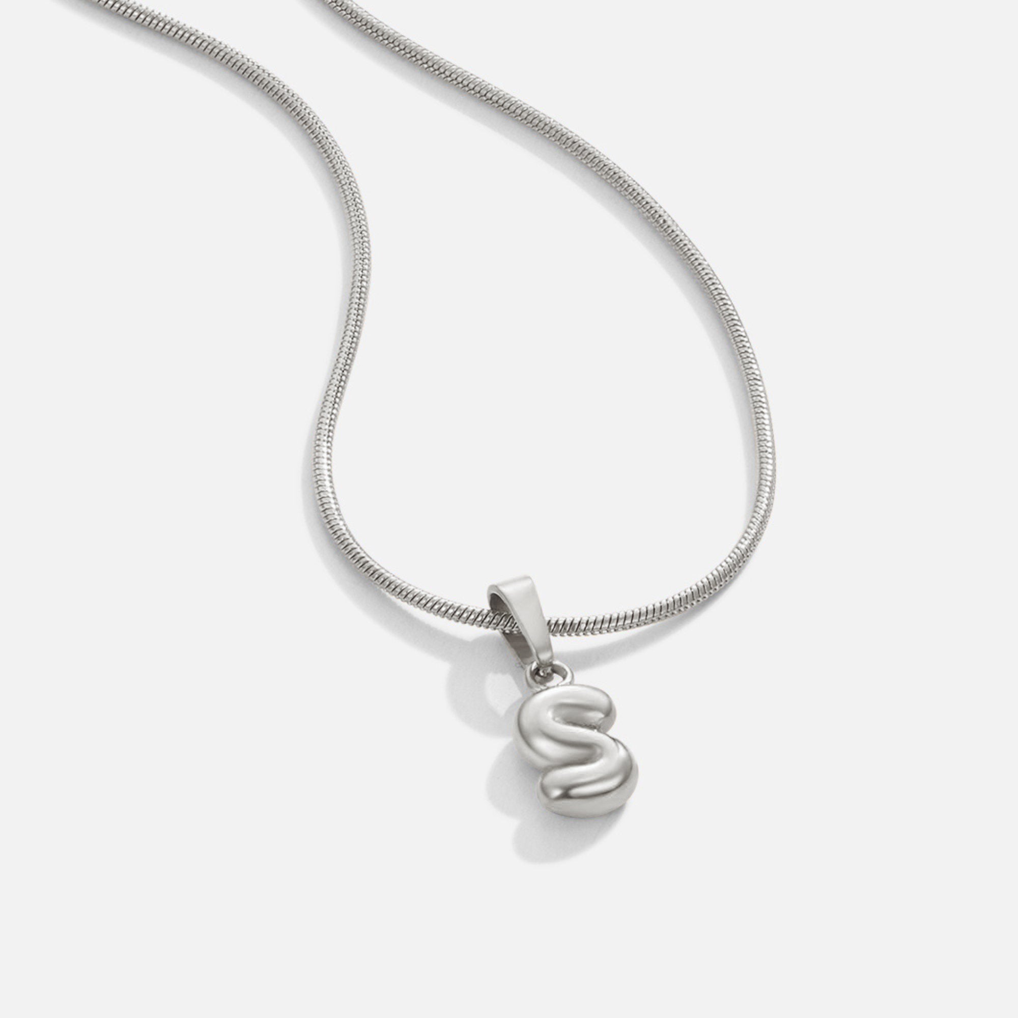 Bubble Letter Necklace, silver snake chain necklace with a puffy bubble letter S pendant on white