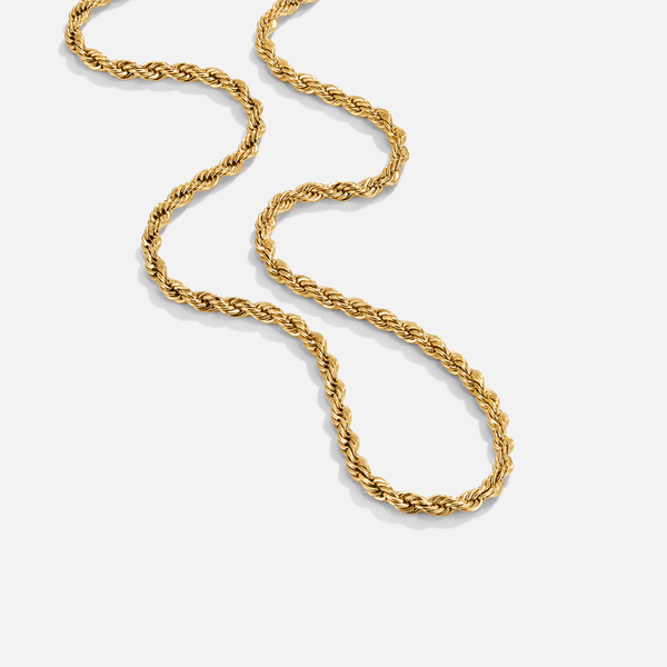 Free Calla Gold Twisted Chain Necklace, gold twisted rope chain laid out in a loose curve on white