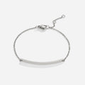 Cara Silver Bracelet, flat lay of a silver chain bracelet with a curved bar and lobster clasp