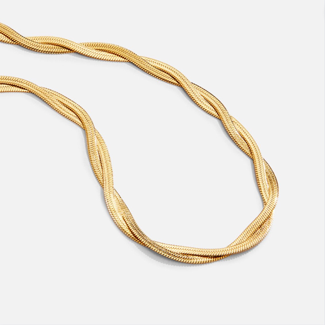 Chiara Twist Snake Chain Necklace, close-up of a twisted gold chain laid in a loop on white