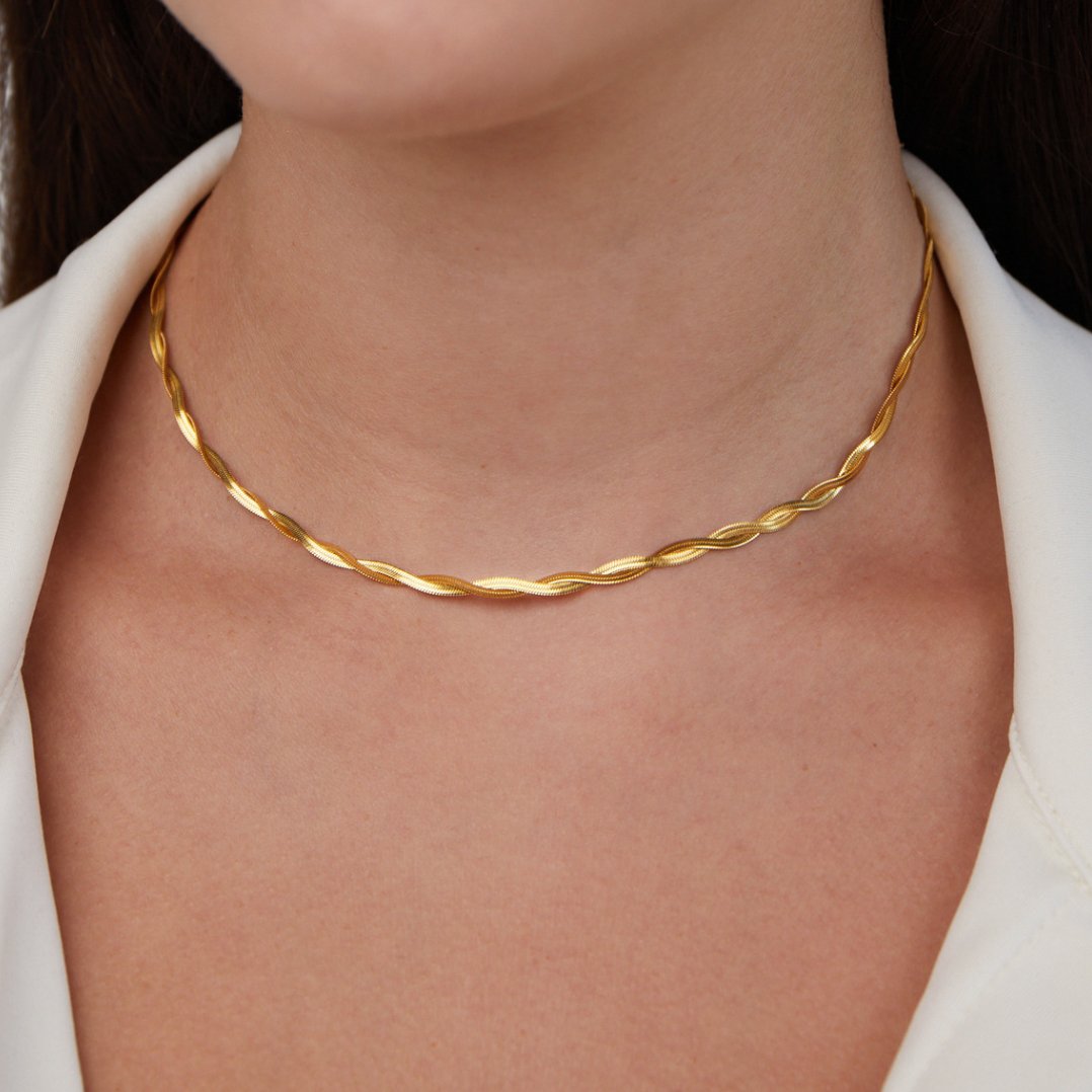 Chiara Twist Snake Chain Necklace, worn on a neck with a white collared top; twisted gold chain