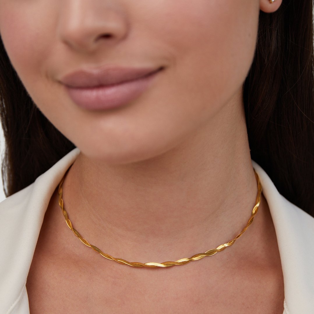 Chiara Twist Snake Chain Necklace, worn at the neck over a white collar, gold twisted chain
