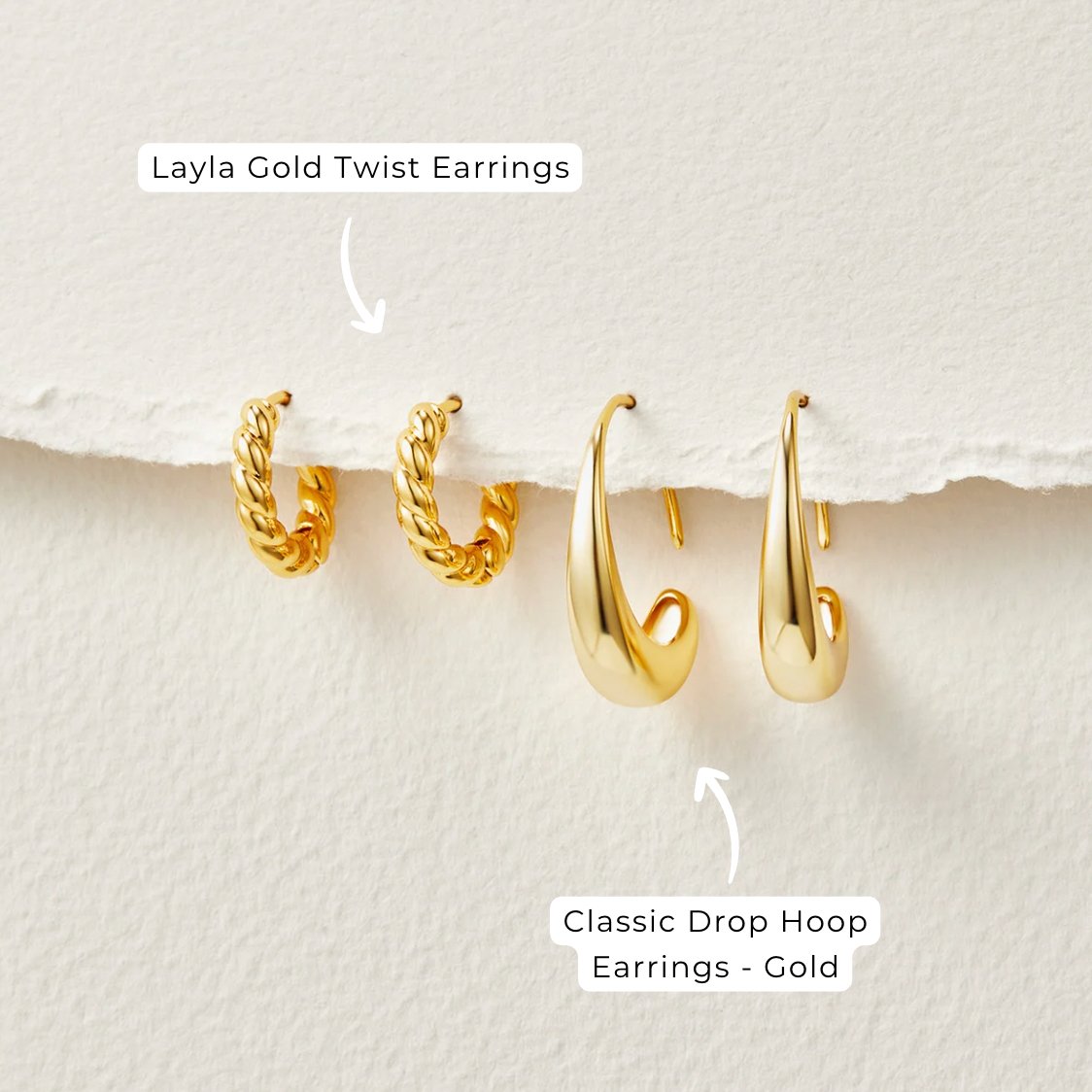 Classic Drop Hoop Earrings, two gold twisted hoops and two gold drop hoops on cream paper