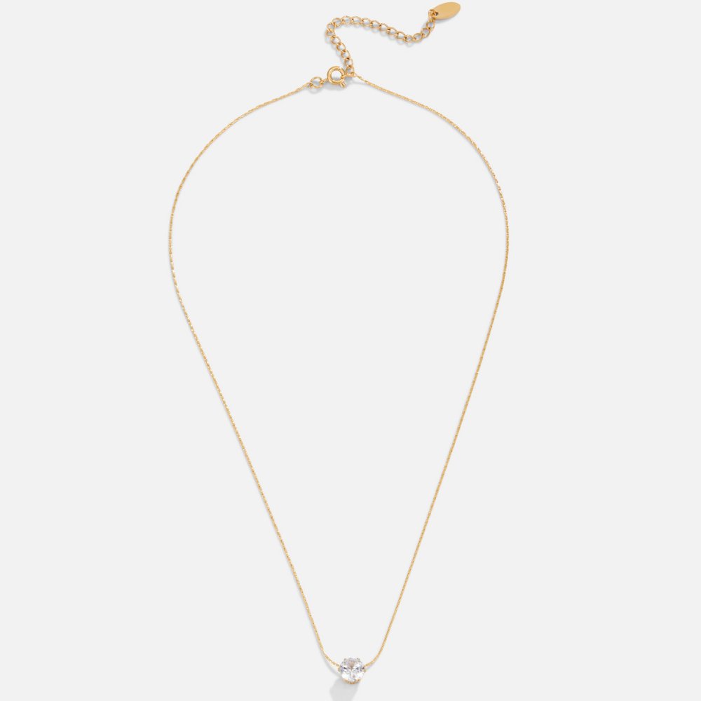 Dainty Round Crystal Necklace, flat lay of a gold chain with a round clear stone at the centre