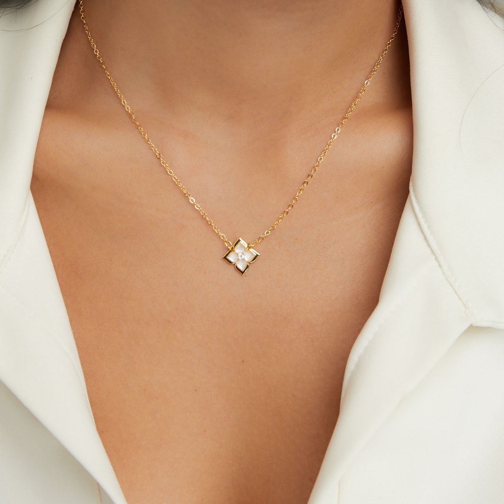 Dalia White Iris Clover Necklace, worn on a neck with a white open-collar shirt