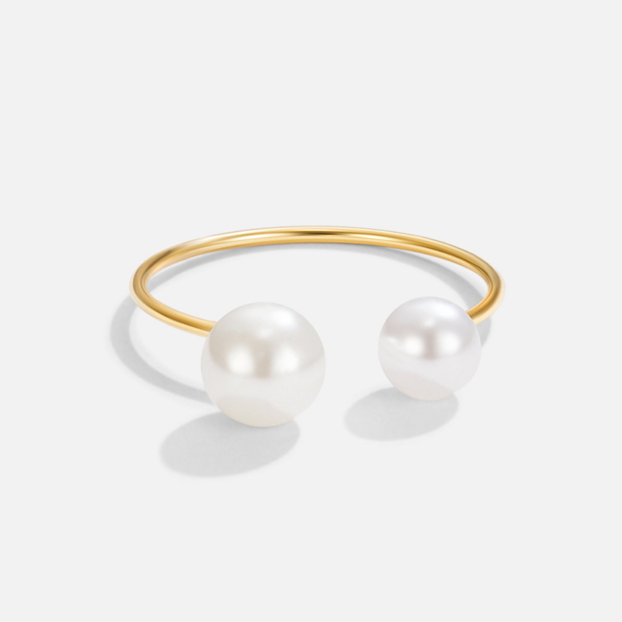Durya Double Pearl Wrap Ring, open gold band with two white pearls on a plain background