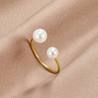 Durya Double Pearl Wrap Ring, open gold band with two white pearls on beige fabric