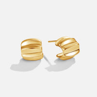 Elsa Mini Wave Hoop Earrings, pair of gold earrings on white background, ridged curved hoops