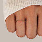 Eternity 18K Crystal Ring, worn on a finger below a cream knit sleeve, close-up