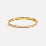 Eternity 18K Crystal Ring, gold band ring lying flat, with a row of clear stones across the front