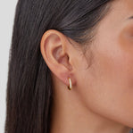 Eternity Hoop Earrings, worn on an ear, gold hoop with small white stones