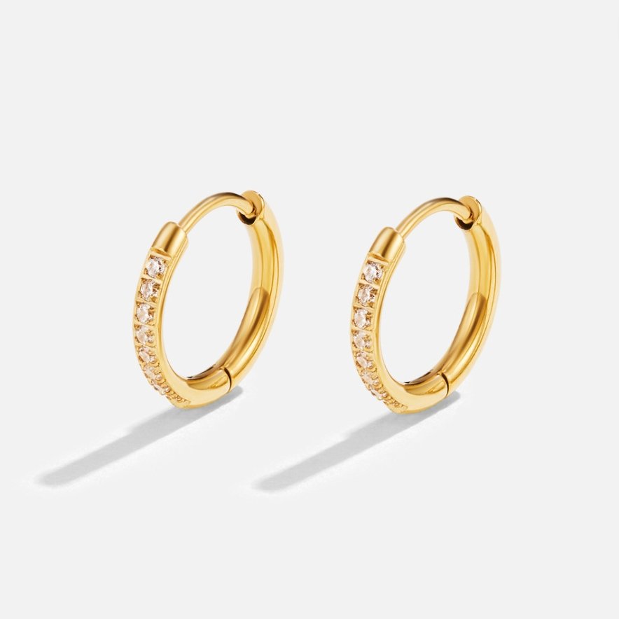 Eternity Hoop Earrings, a pair of gold hoops with small clear stones on white