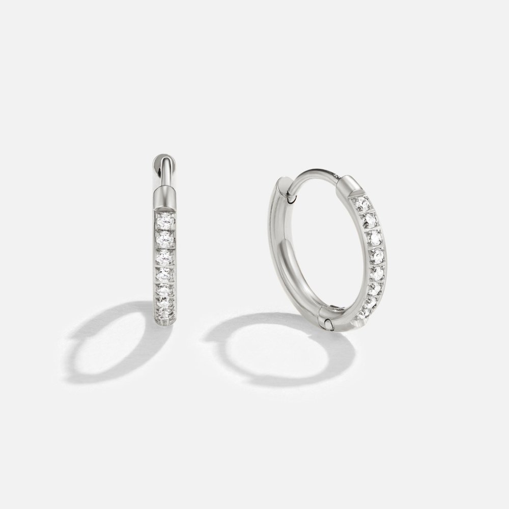 Eternity Hoop Earrings, pair of silver hoops on white, one edge-on, one face-on with crystals