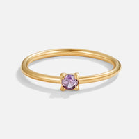 February Birthstone 18K Gold Ring, gold band with a small four-prong purple stone, on white
