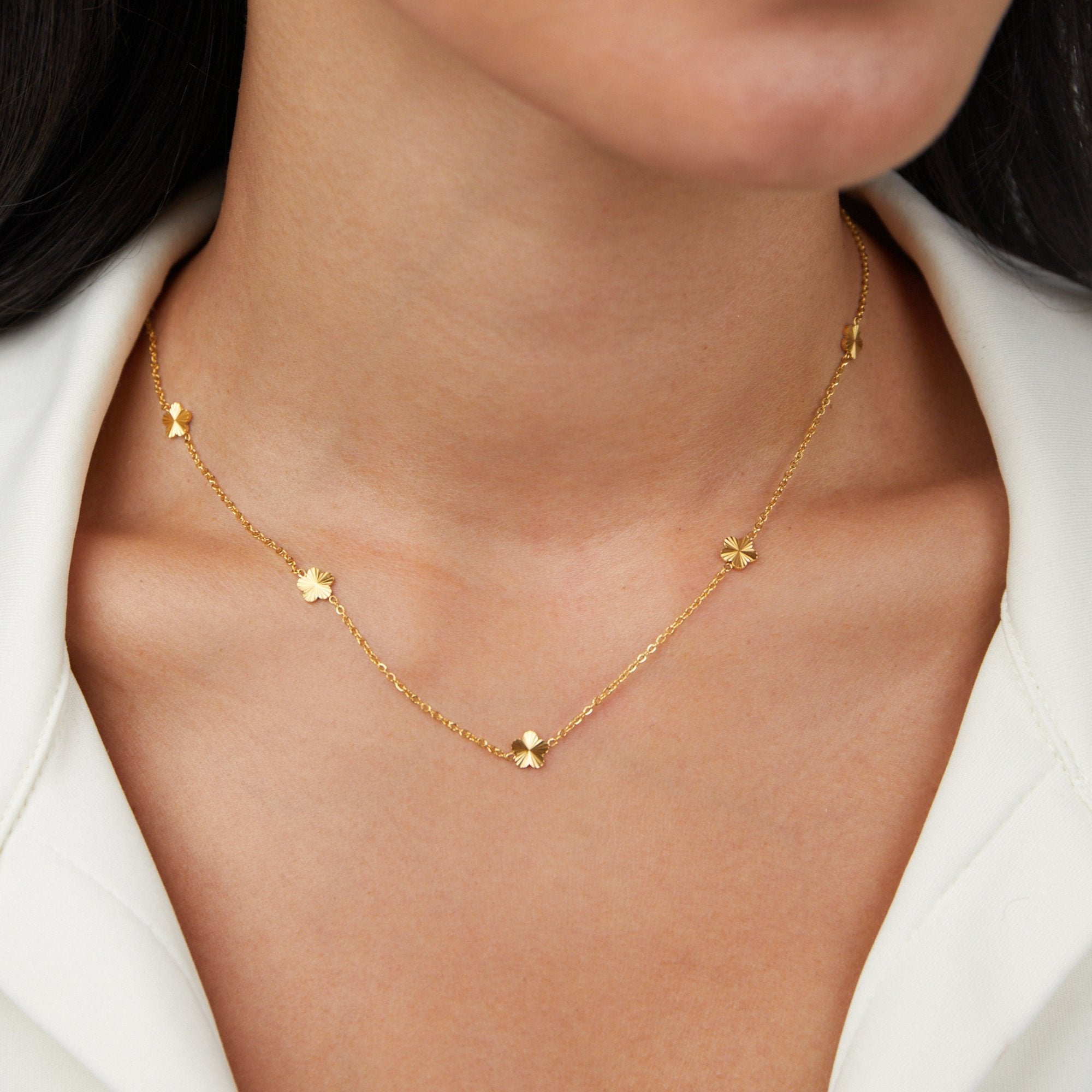 Flower Power 18K Gold Chain Necklace, worn on a model in a white collared top, close-up on the neck